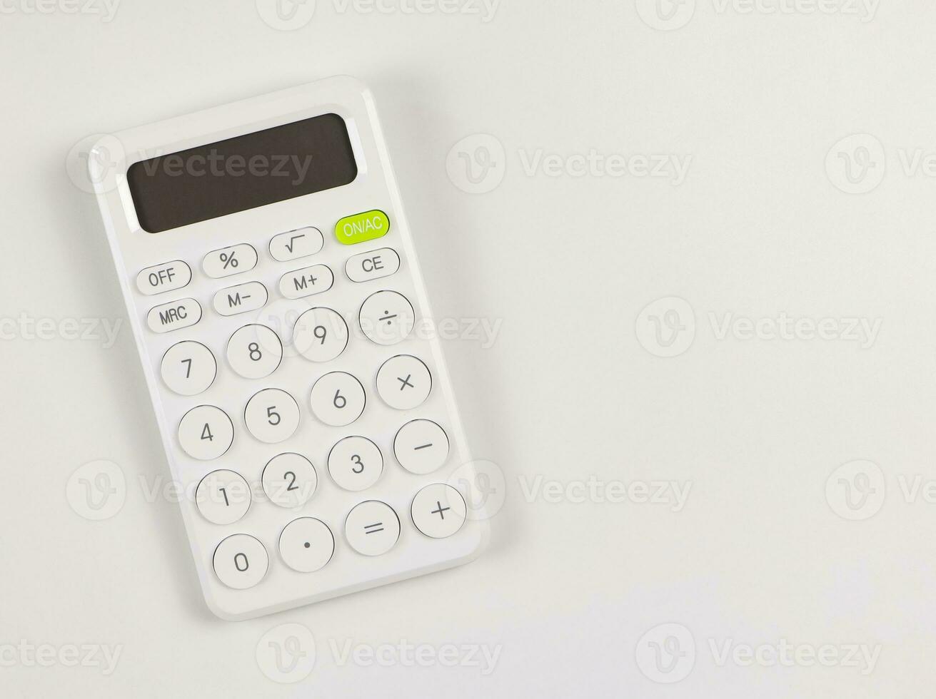 flat lay of white calculator on white background with copy space. photo