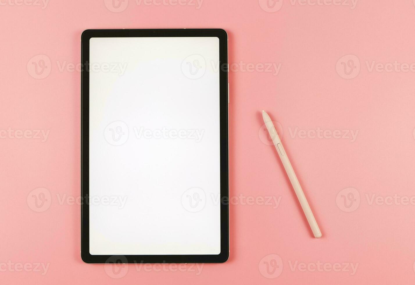 flat lay of digital tablet with blank white screen and pink stylus pen isolated on pink background. photo
