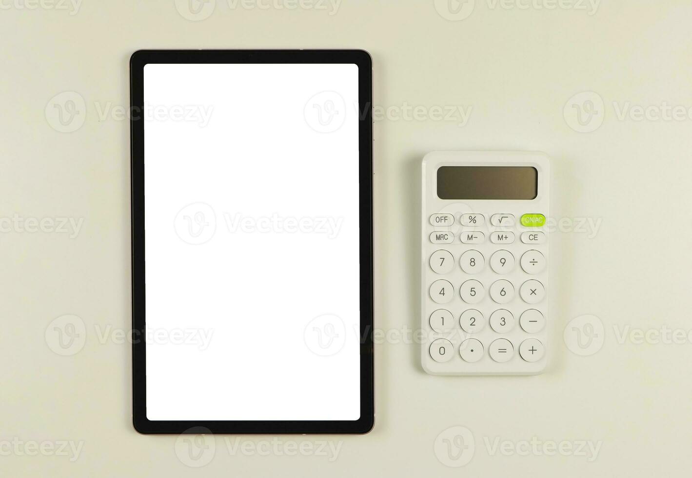 lat lay of digital tablet with blank white screen,   and white calculator  isolated on white background. photo