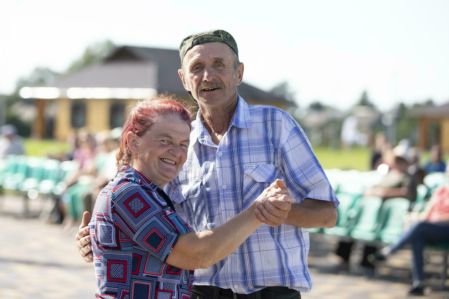 08 29 2020 Belarus, Lyaskovichi. Dance floor for the elderly. Elderly man and woman are dancing. photo