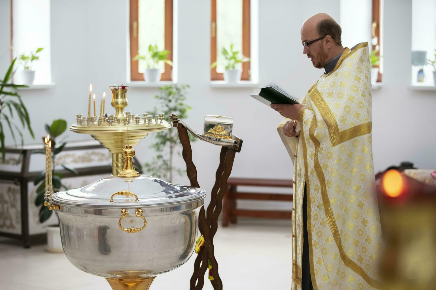 July 15, 2020 Belarus, city of Gomel. City church. The priest reads a prayer before the baptism of the child. photo