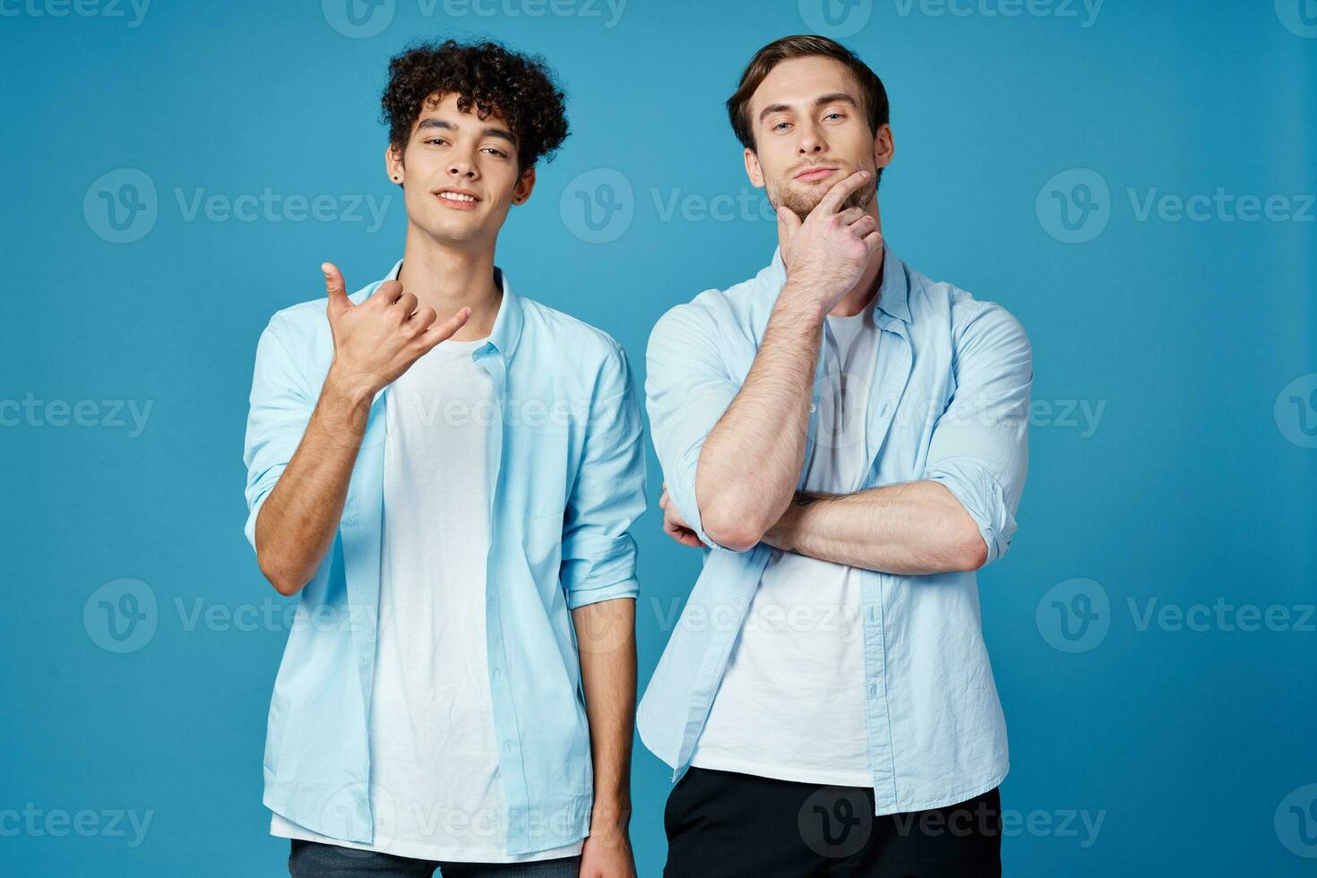 two friends in shirts stand side by side communication isolated background photo