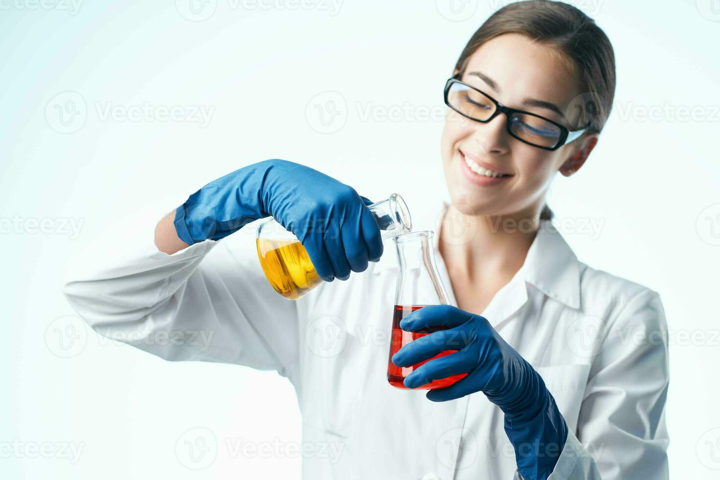 Woman in white coat laboratory assistant chemical solution research analyzes photo