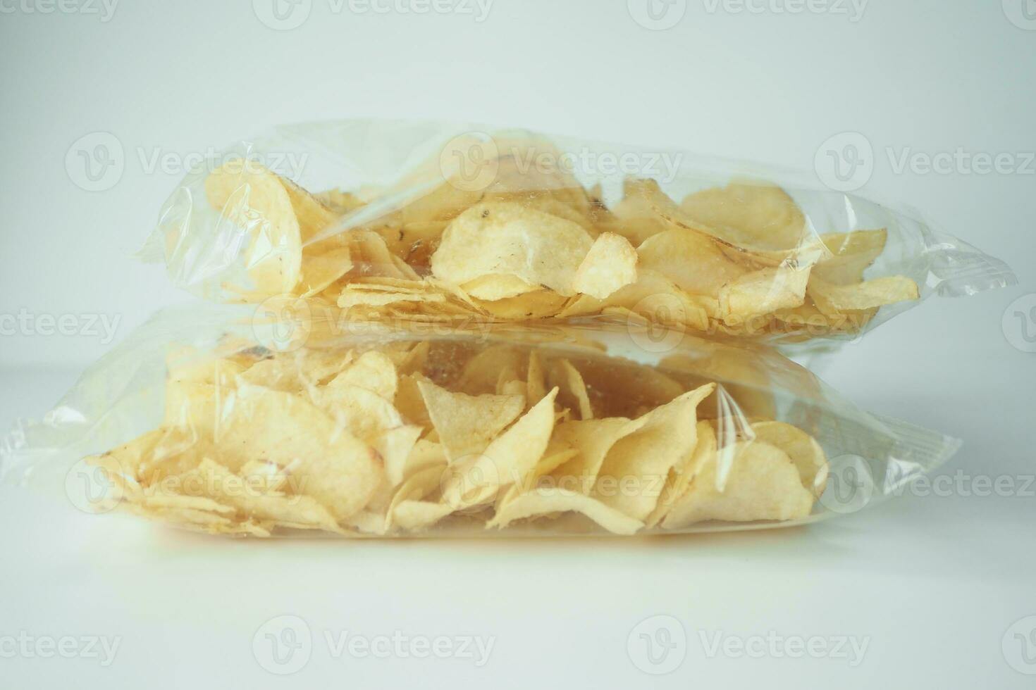 tasty potato chips in a packet on white background photo