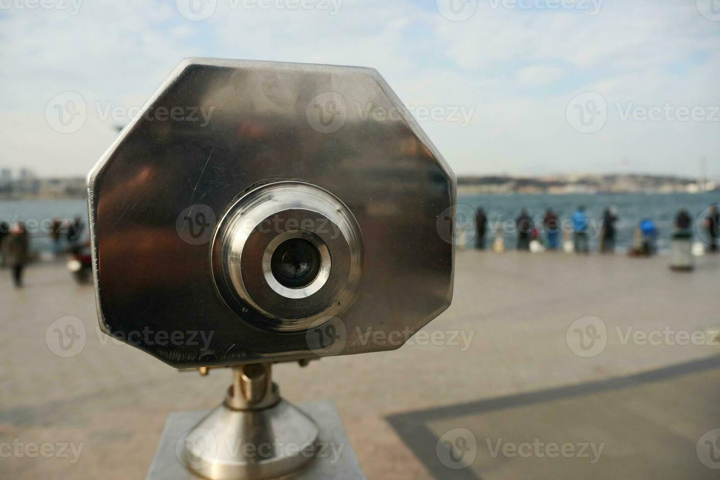 Coin-operated binoculars looking out over city , photo