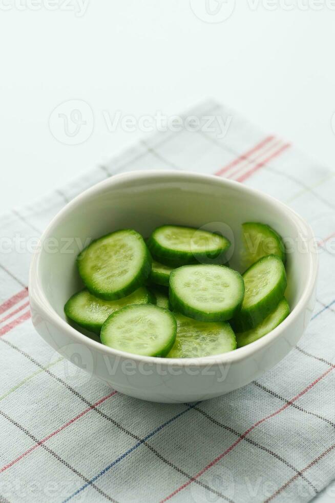 close up of slice of cucumber in a bowl on table photo