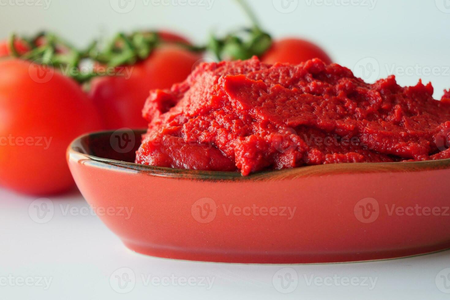 Tomato paste with ripe tomatoes. photo