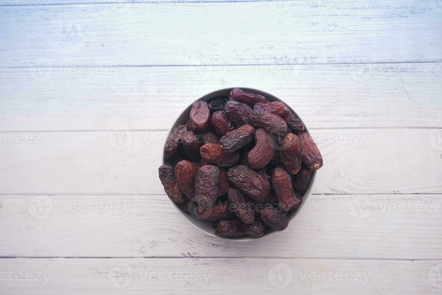 close up of fresh date fruit in a bowl on table photo