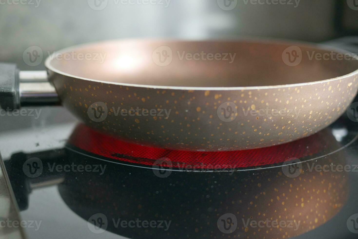 cooking pan on electric stove, electric stove is heated to red. photo