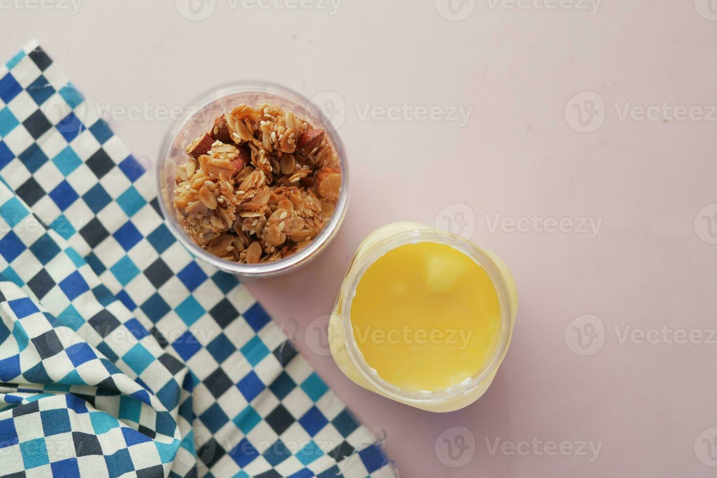 yogurt and granola Musli in a bowl with table cloth photo