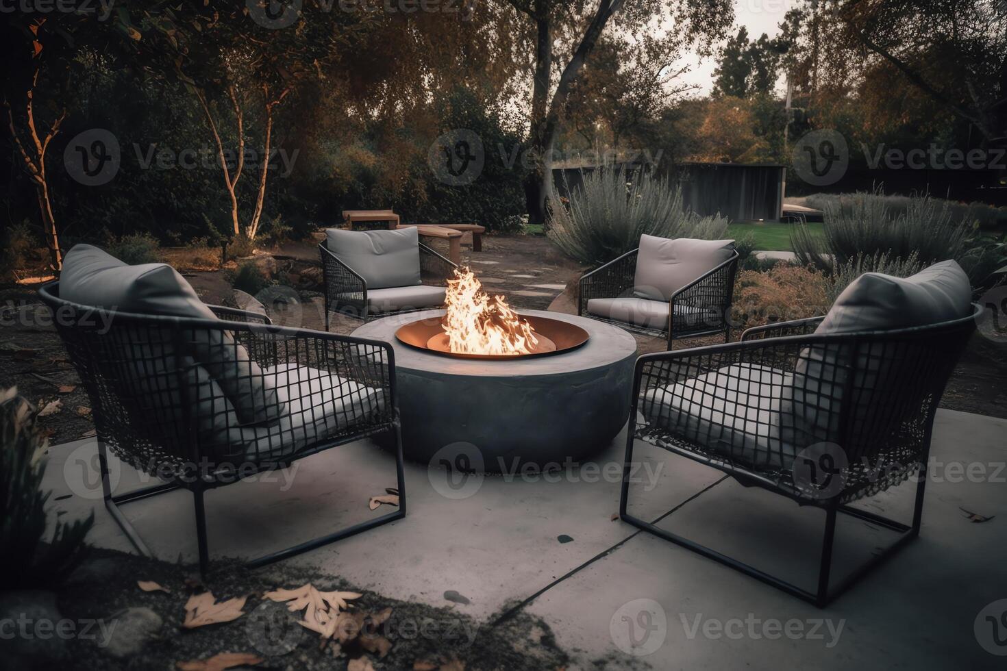 Outdoor backyard fire pit with grey modern furniture outdoor chairs seating on a sunset residential house terrace. photo