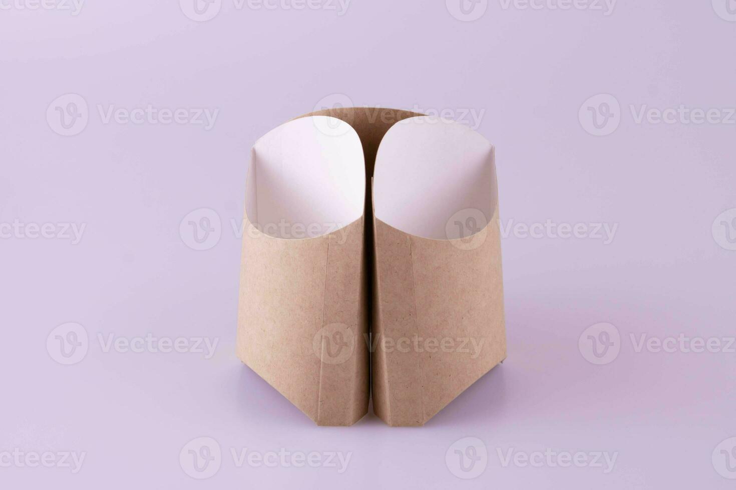 Three gray empty containers for French fries on a pink background photo