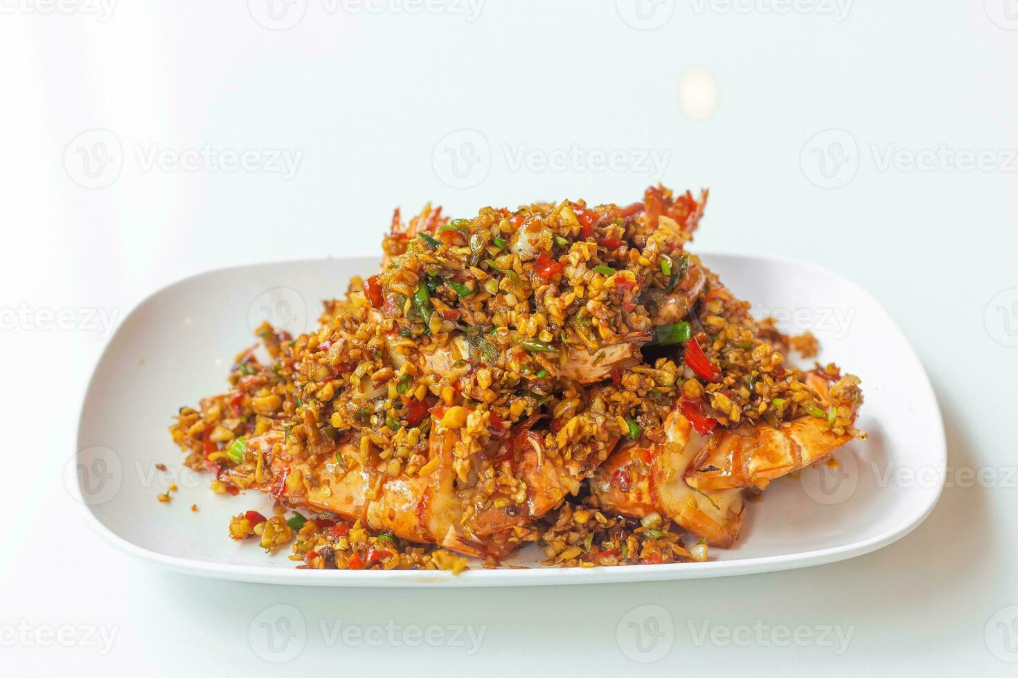 Stir Fried Prawn with Chili and Salt It is Thai Asian food with a mellow spicy taste as seafood in a white plate. photo