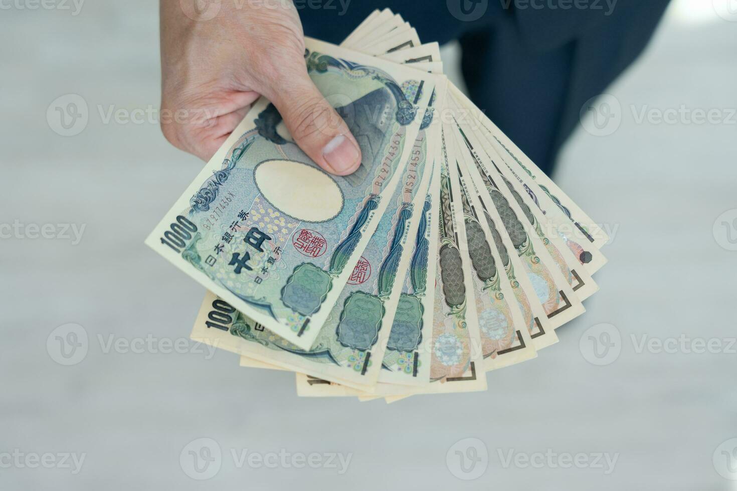 Japanese Yen money. close up of the Japanese yen on hand. currency of Japan that is used to change, buy, sell, accumulate, invest, financial, exchange rate, value, accounting, international exchange photo