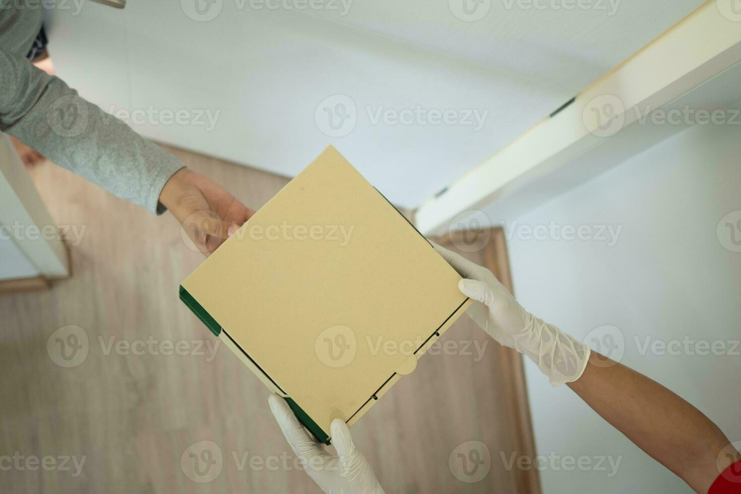 woman receives boxes parcel from courier in front house. Delivery man send deliver express. online shopping, paper containers, takeaway, postman, delivery service, packages photo