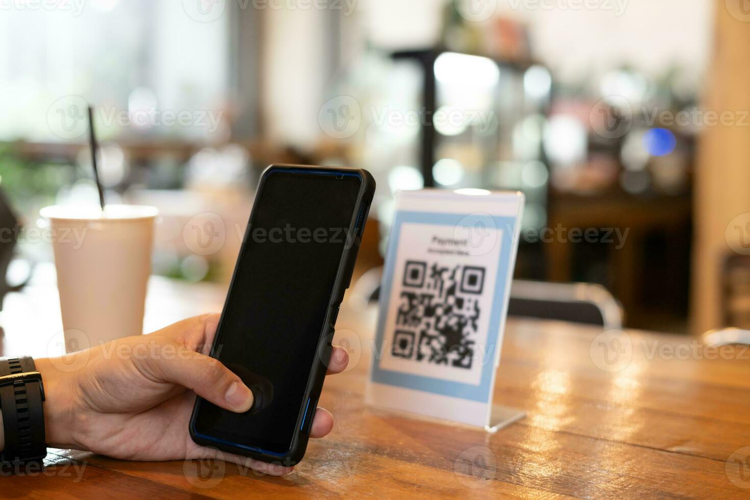 man use smartphone to scan QR code for order menu in cafe restaurant with a digital delivery. Choose menu and order accumulate discount. E wallet, technology, pay online, credit card, bank app. photo