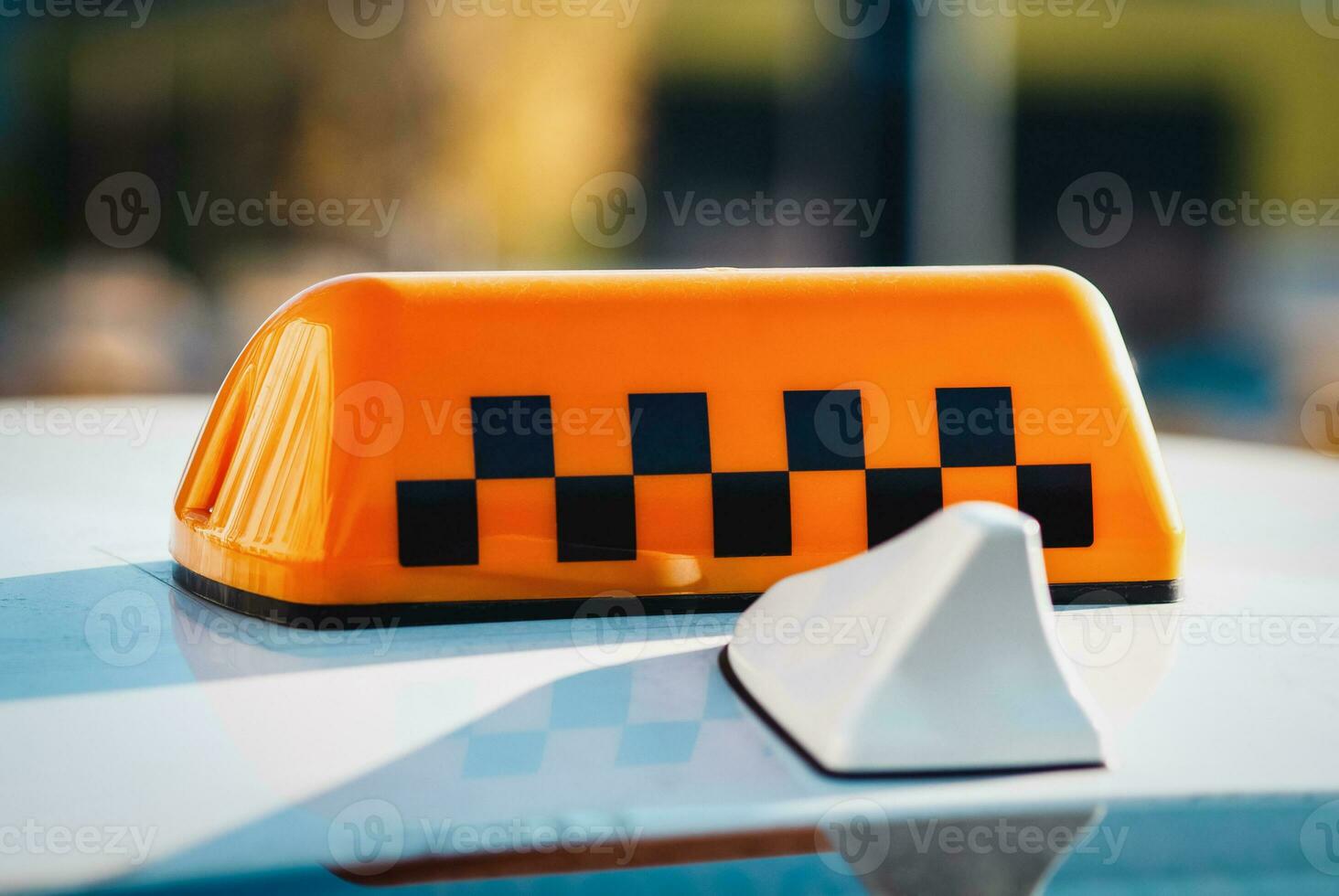 Checkered taxi sign on top of the car closeup photo