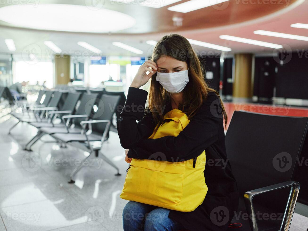 sad woman in medical mask airport waiting passenger photo
