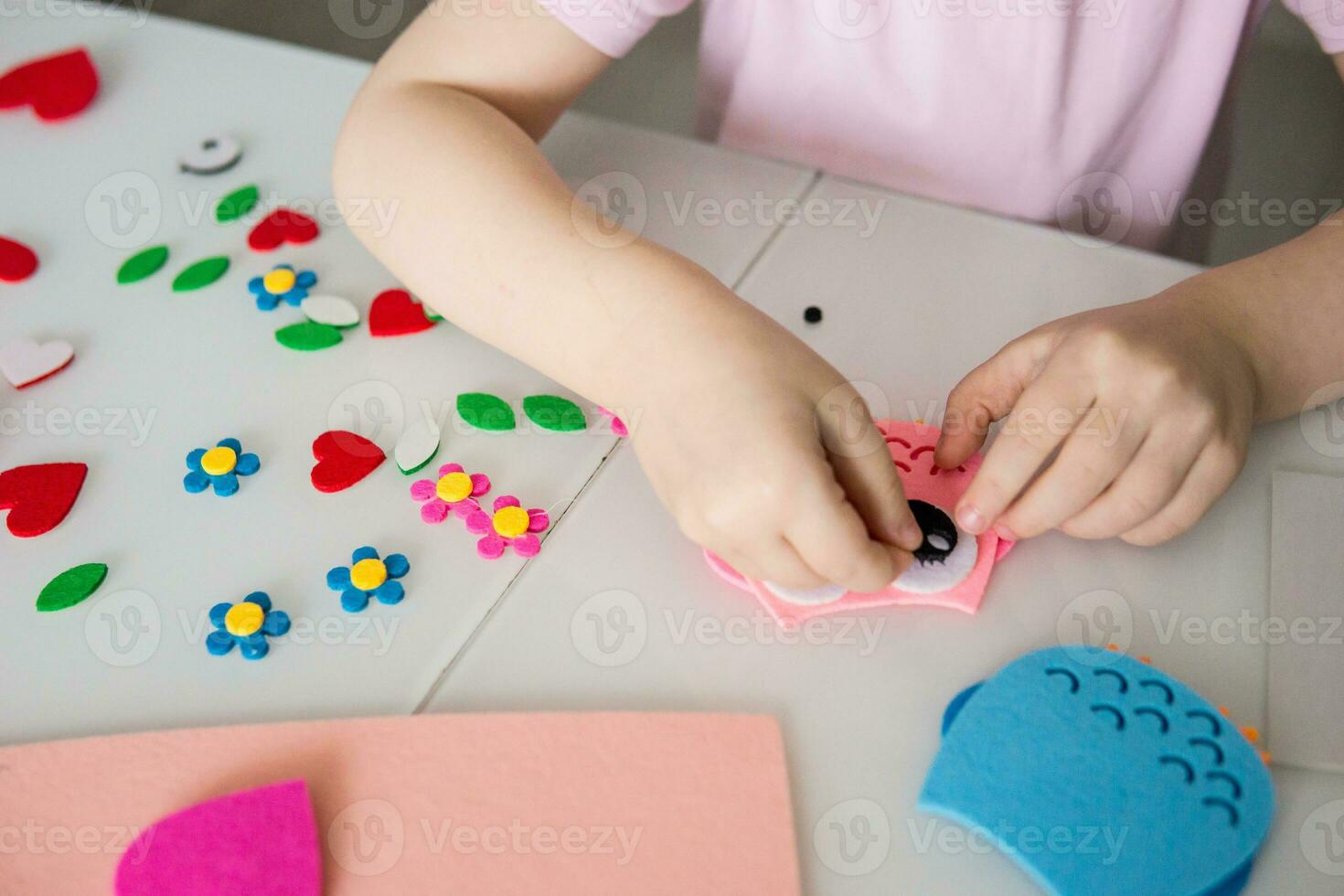 un blogger niña hace un sintió arte para San Valentín día en el forma de un corazón. el concepto de para niños creatividad y hecho a mano. foto