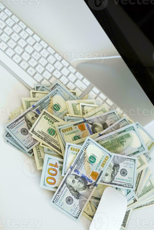 Dollar bills on the white computer keyboard photo