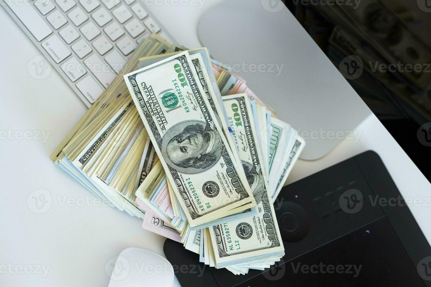 Dollar bills on the white computer keyboard photo