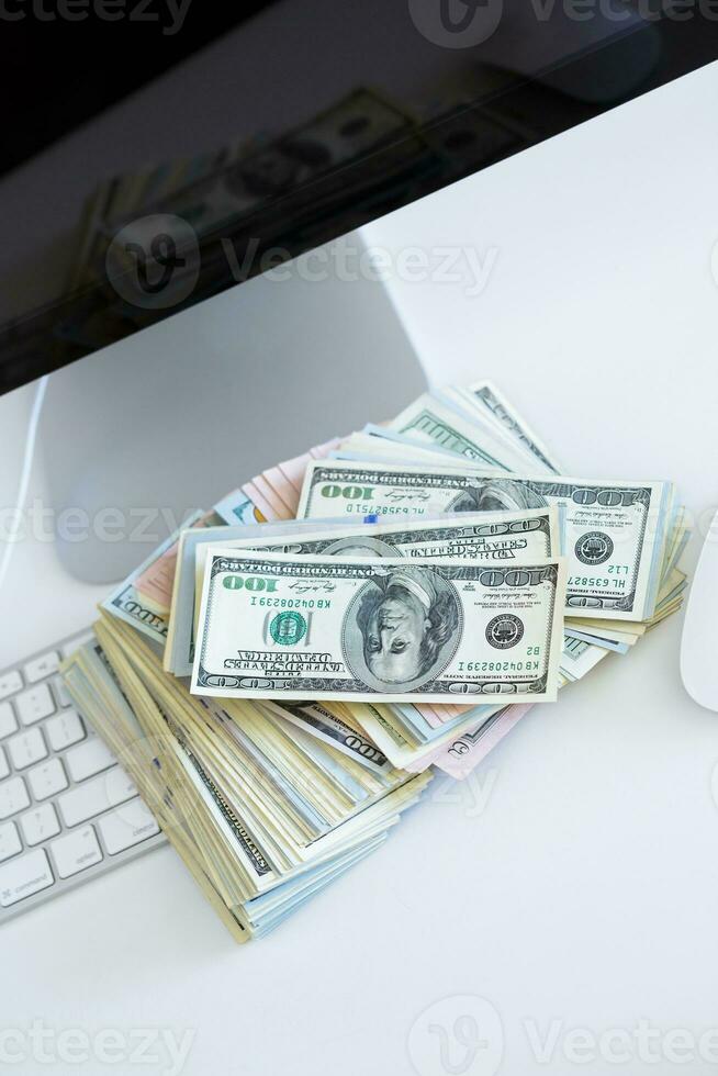 Dollar bills on the white computer keyboard photo