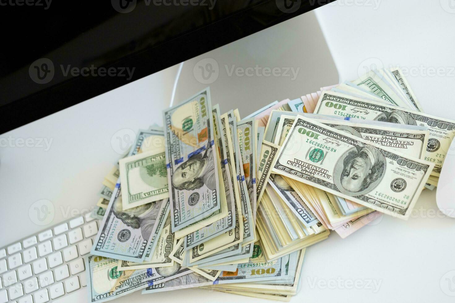 Dollar bills on the white computer keyboard photo