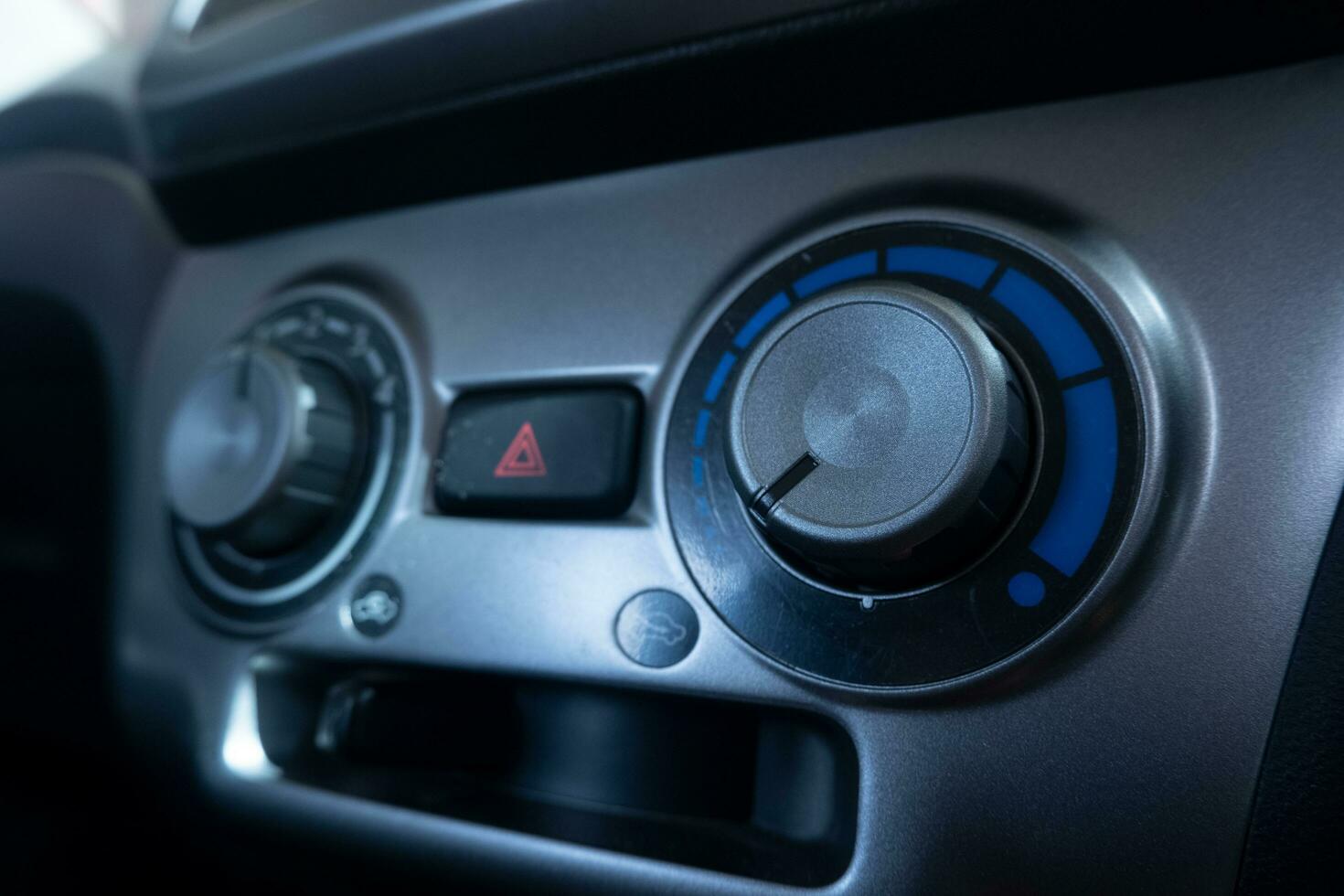 selectively focus on the air conditioner AC control panel on the car dashboard. soft focus. under exposure photo