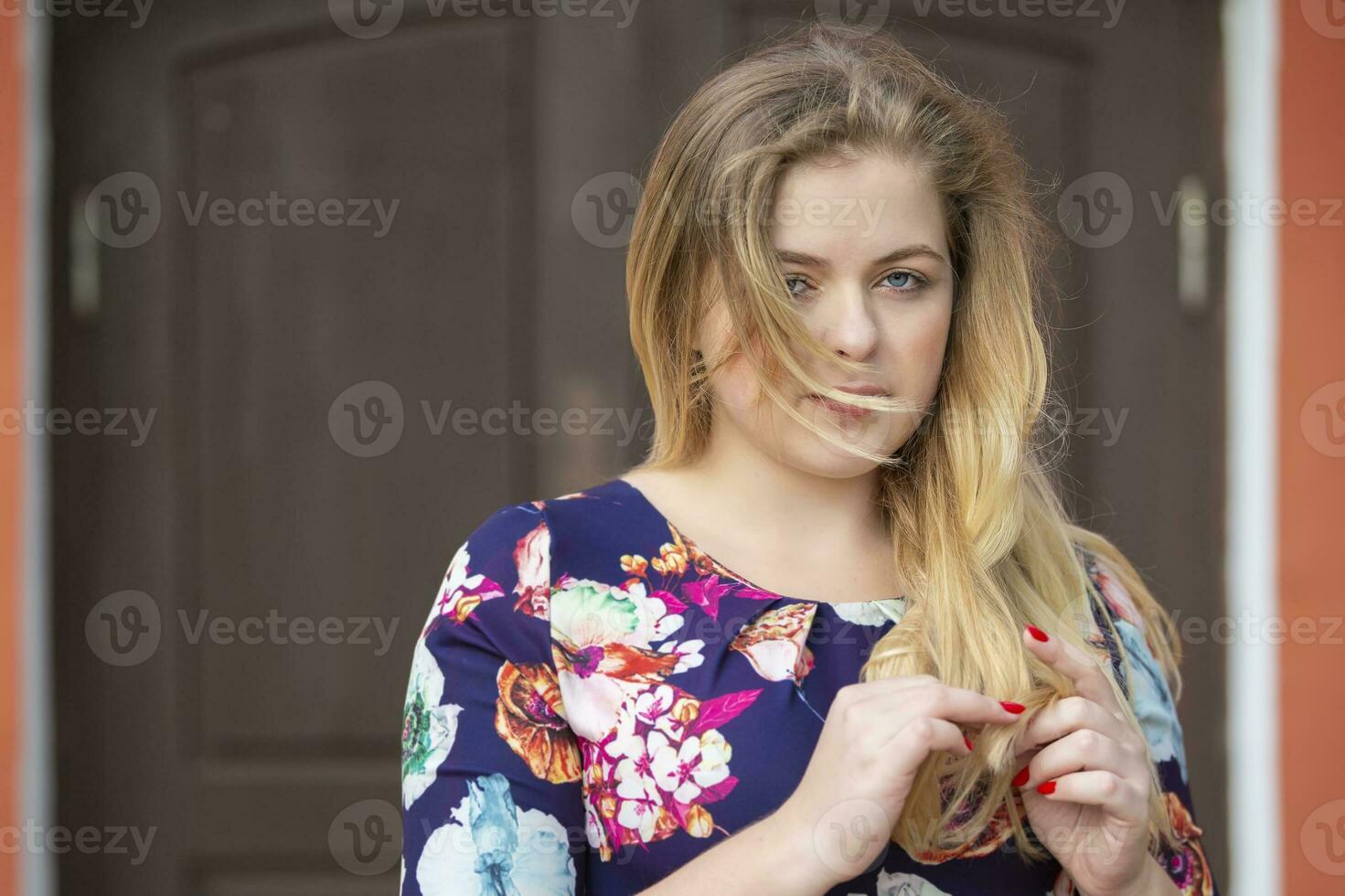 Sad pensive blonde girl with blue eyes on the street. photo