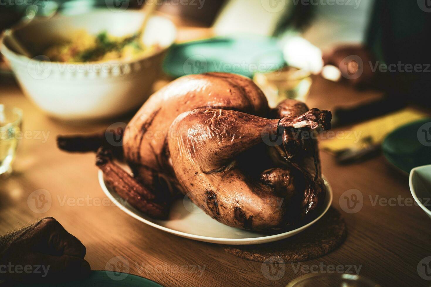 Thanksgiving dinner cooked turkey on wooden table photo