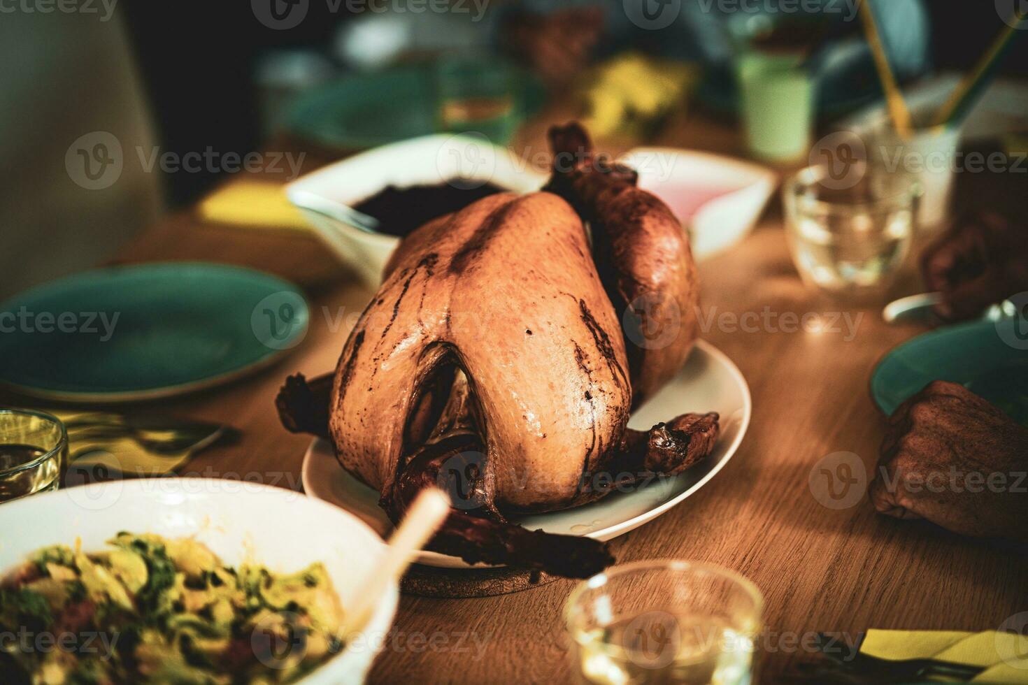 Thanksgiving dinner cooked turkey on wooden table photo