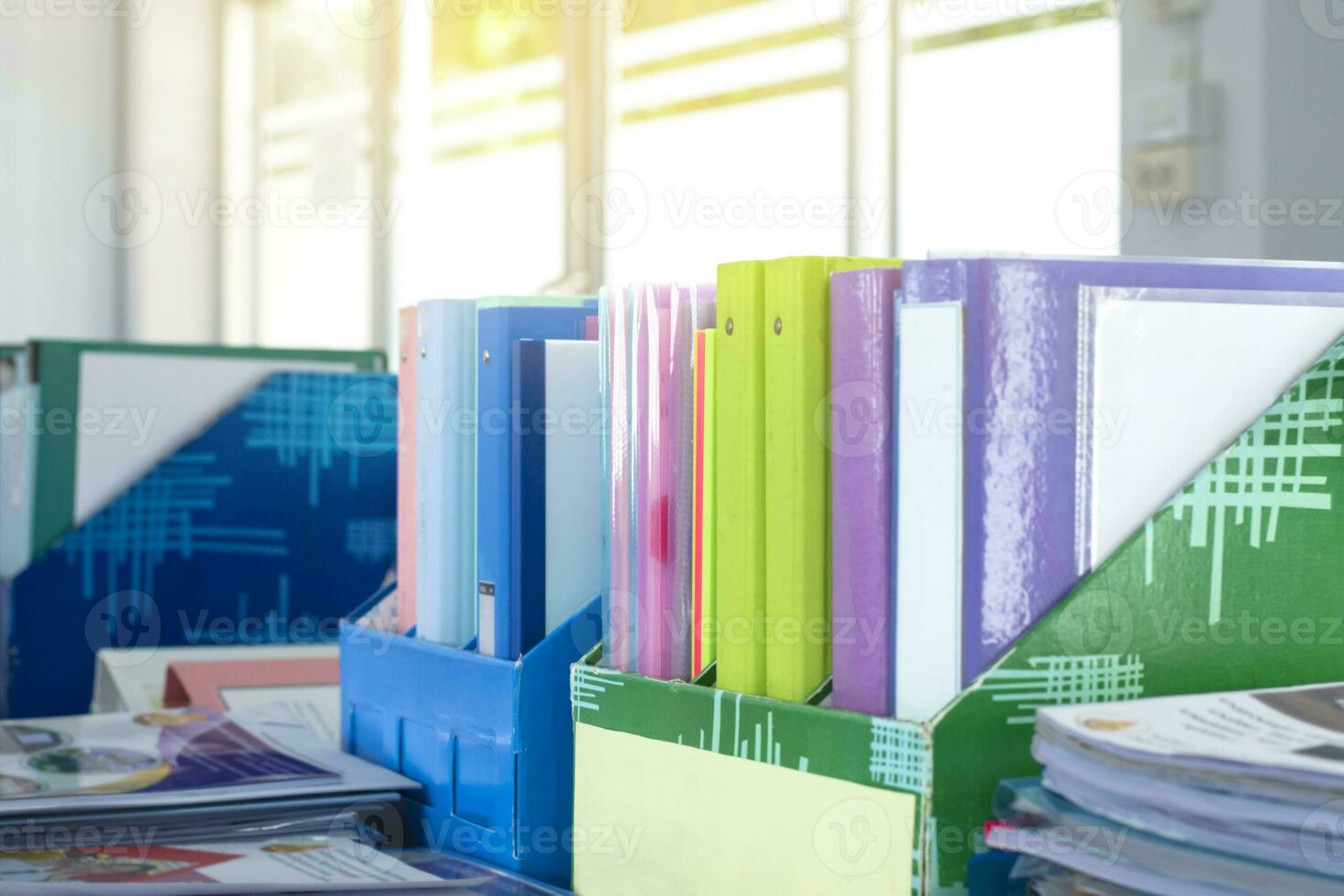 Colorful folders of personnel and office staff are kept and sorted in boxes in the office to evaluate their performance in order to raise their salary or increase their annual remuneration. photo