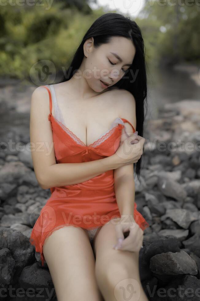 Portrait of sexy asian woman at the waterfall,Feeling fresh at the river,Thai female relax at countr photo