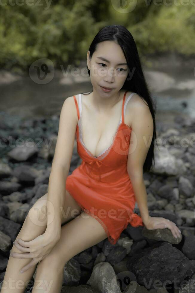 Portrait of sexy asian woman at the waterfall,Feeling fresh at the river,Thai female relax at countr photo