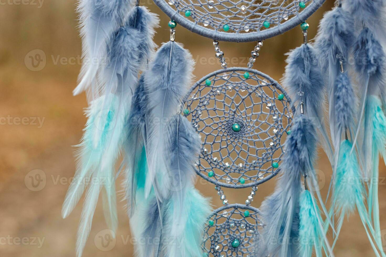 Handmade dream catcher with feathers threads and beads rope hanging photo