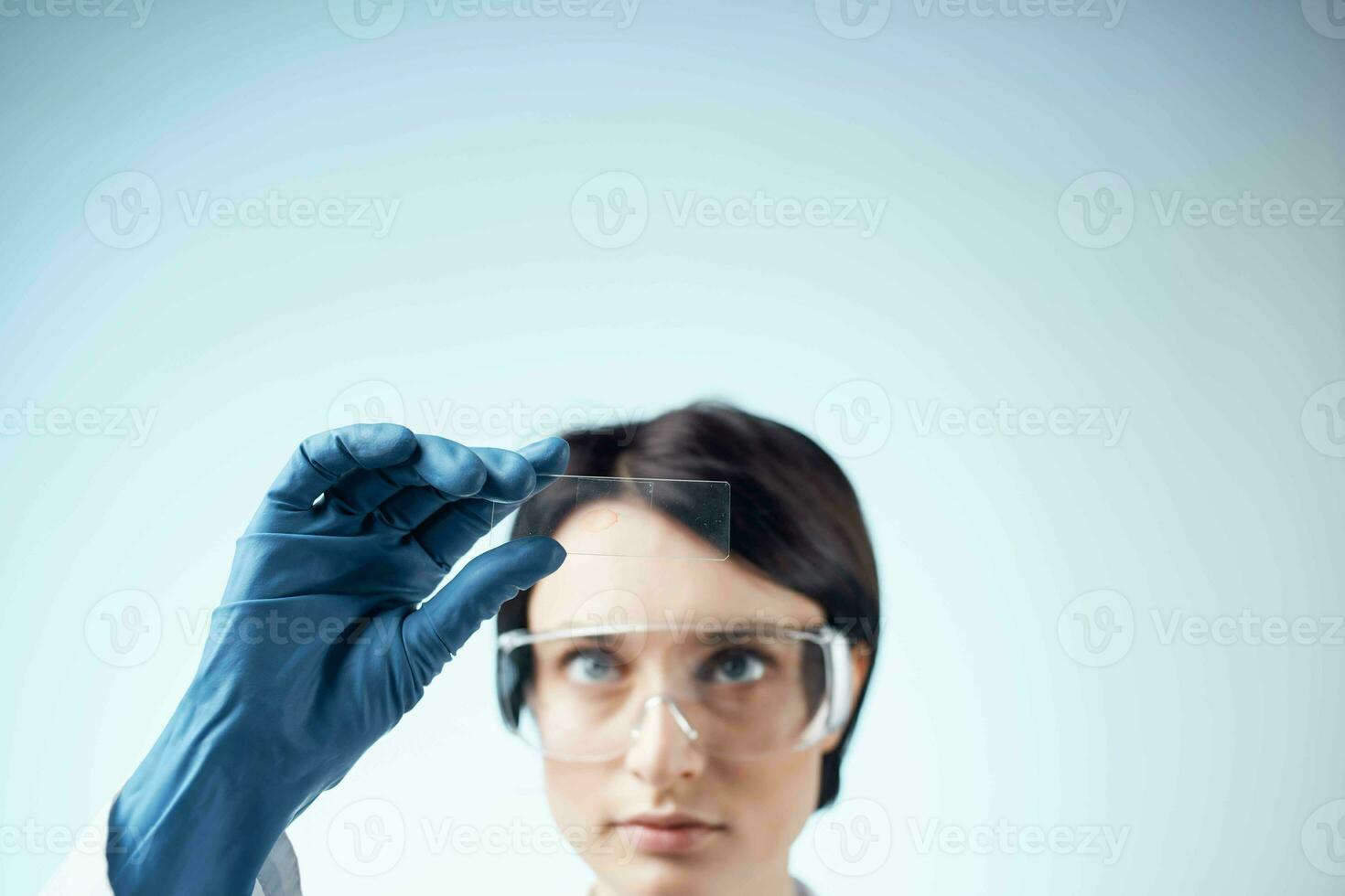 female laboratory assistant in a white coat analysis diagnostics biology photo