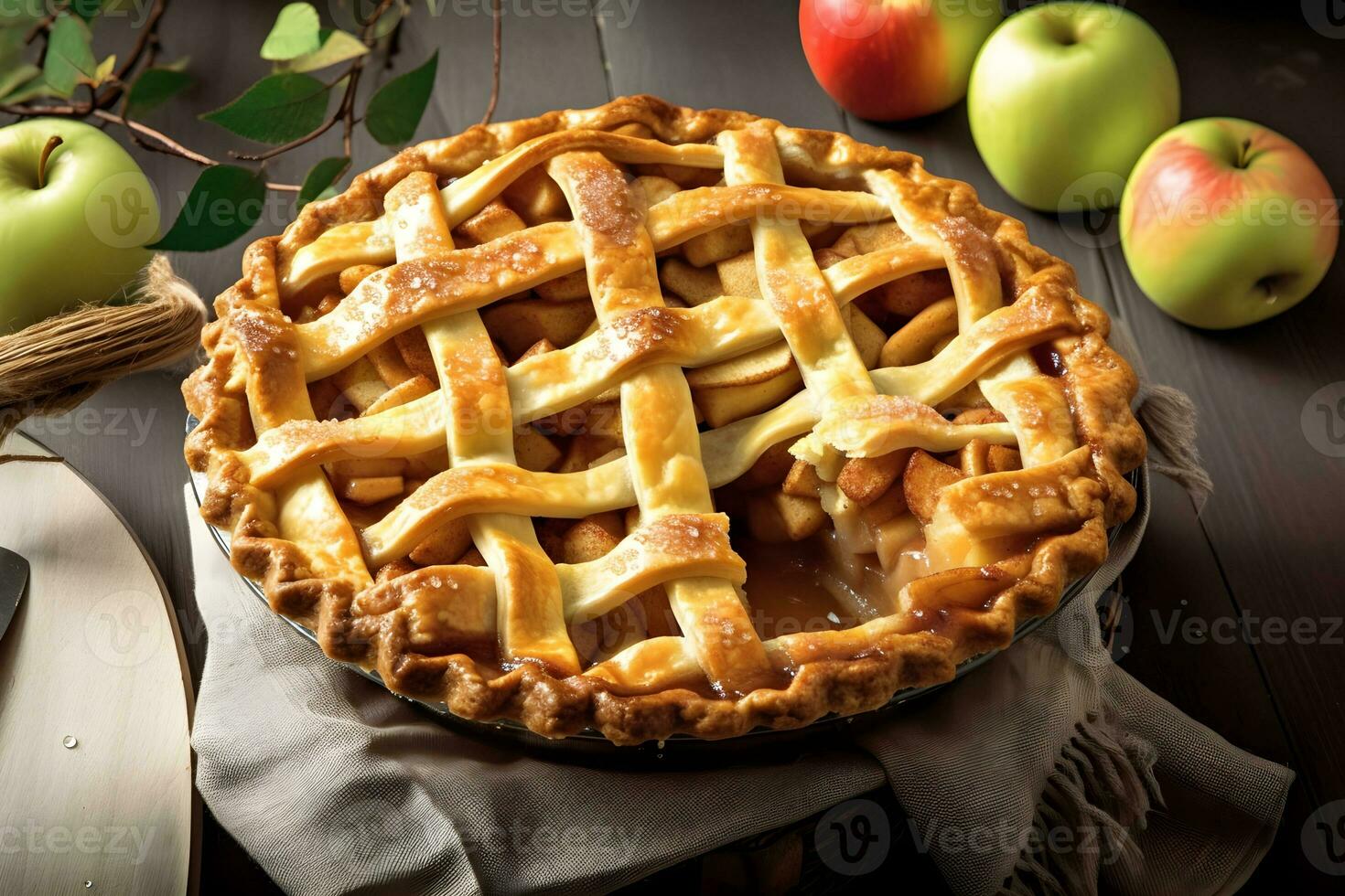 A pie with a lattice crust sits on a table next to a basket of apples photo