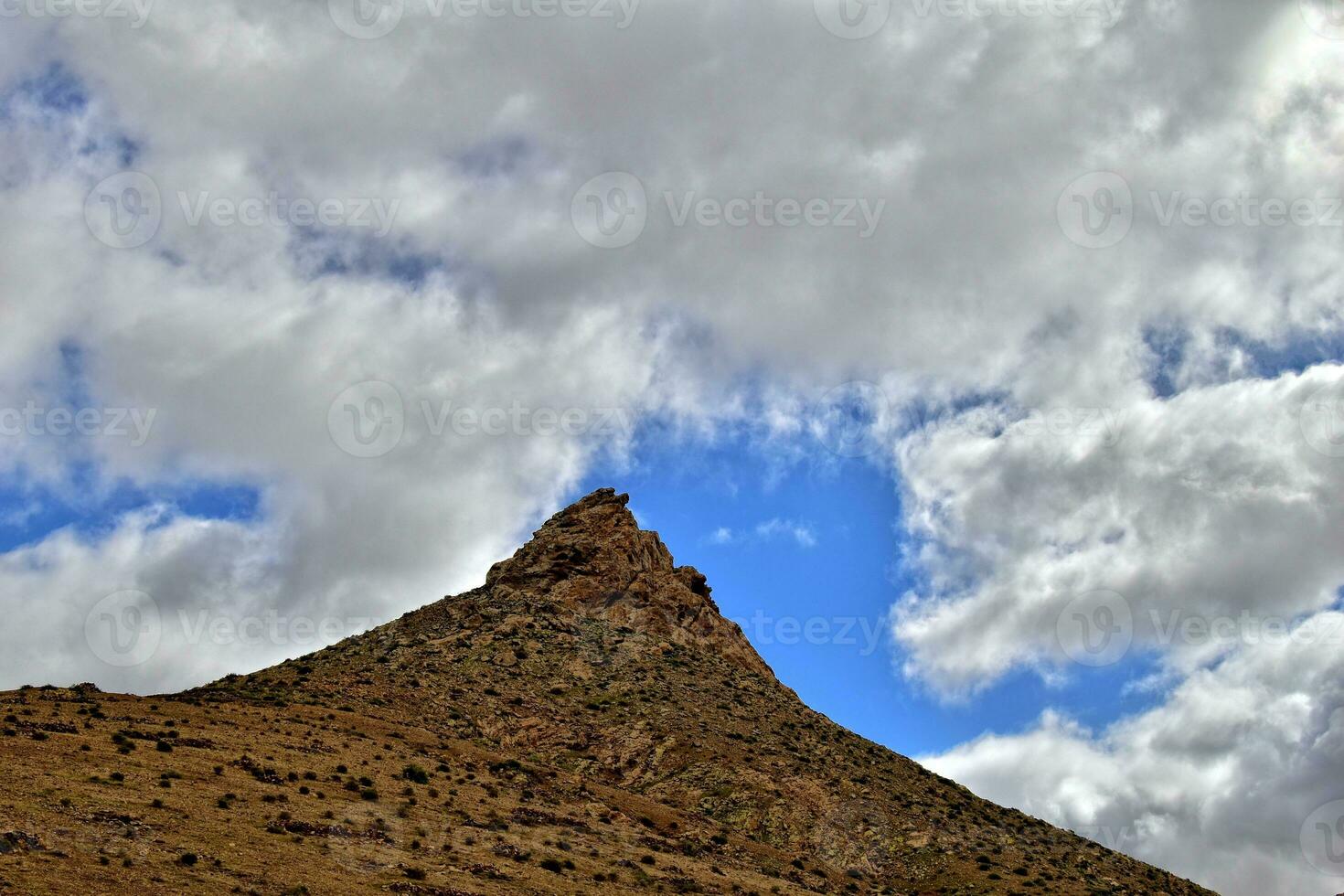 empty mysterious mountainous landscape from the center of the Canary Island Spanish Fuerteventura with a cloudy sky photo