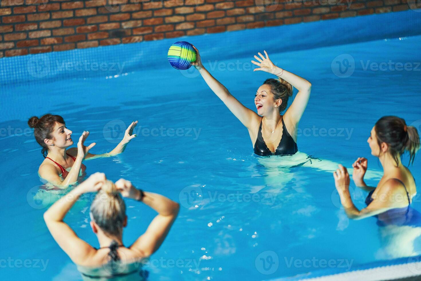 Group of woman in pool having training photo