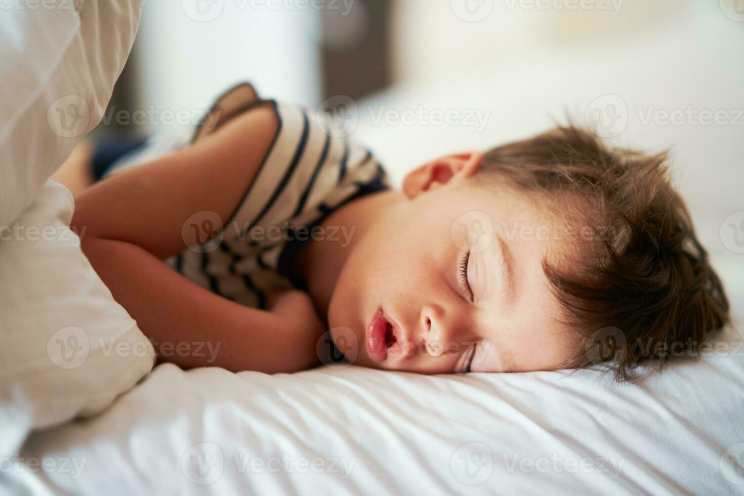 Picture of a tired young boy sleep on holidays photo