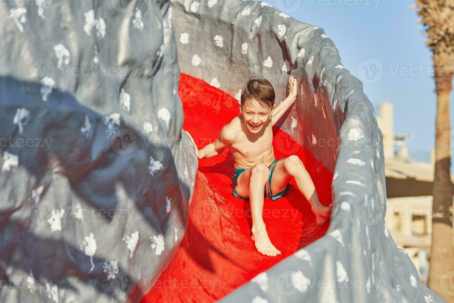 Picture of young boy playing in outdoor aqua park photo