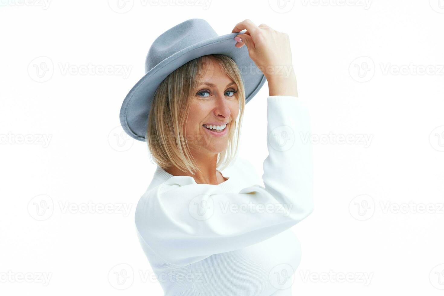 Picture of blonde woman isolated over white background wearing hat photo