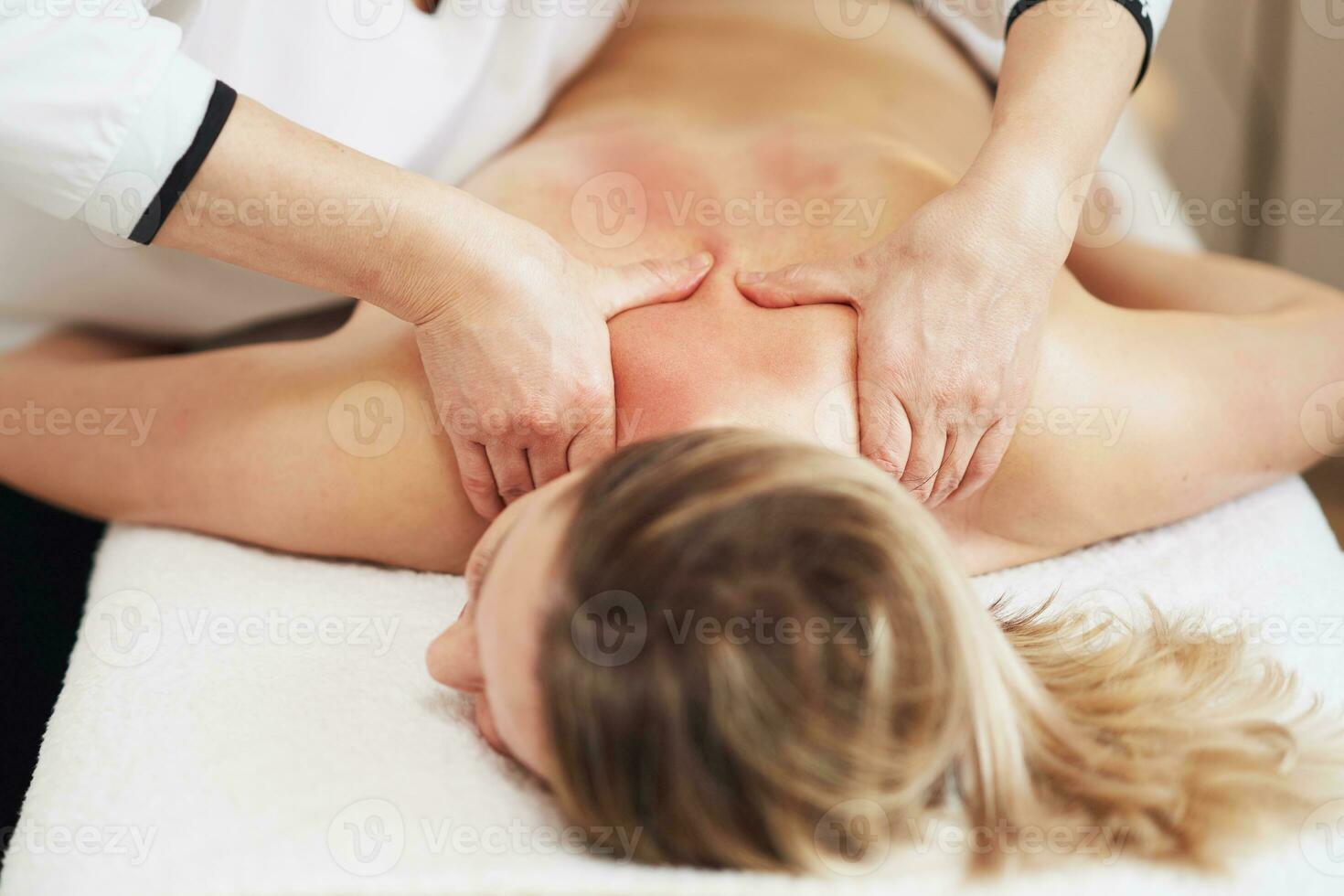 Woman having back body massage in studio photo