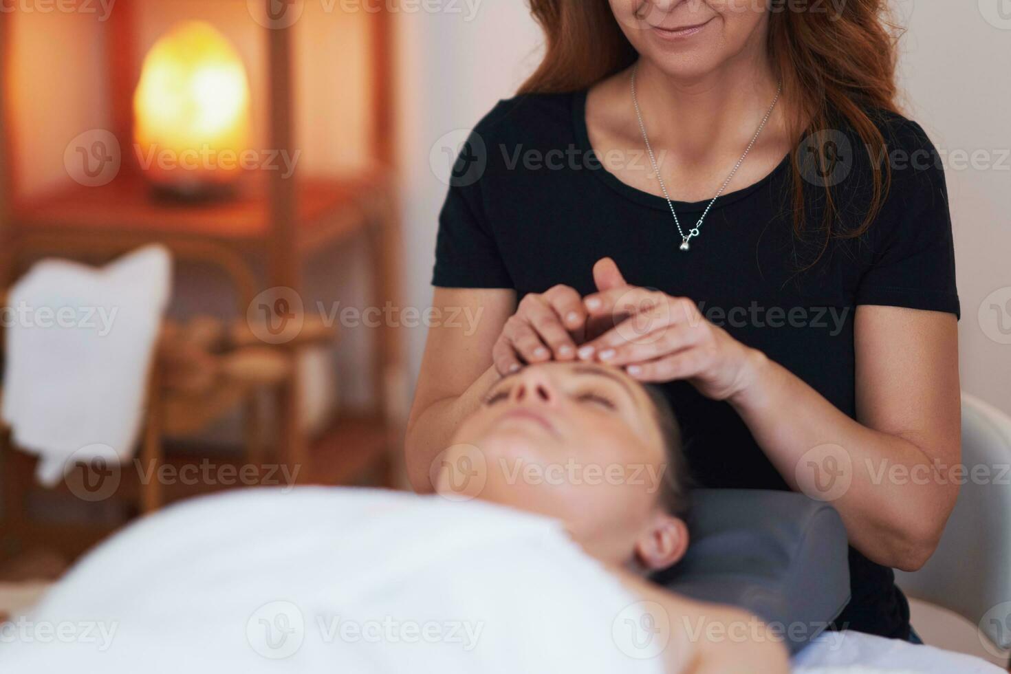 Woman having a face massage treatment in studio photo