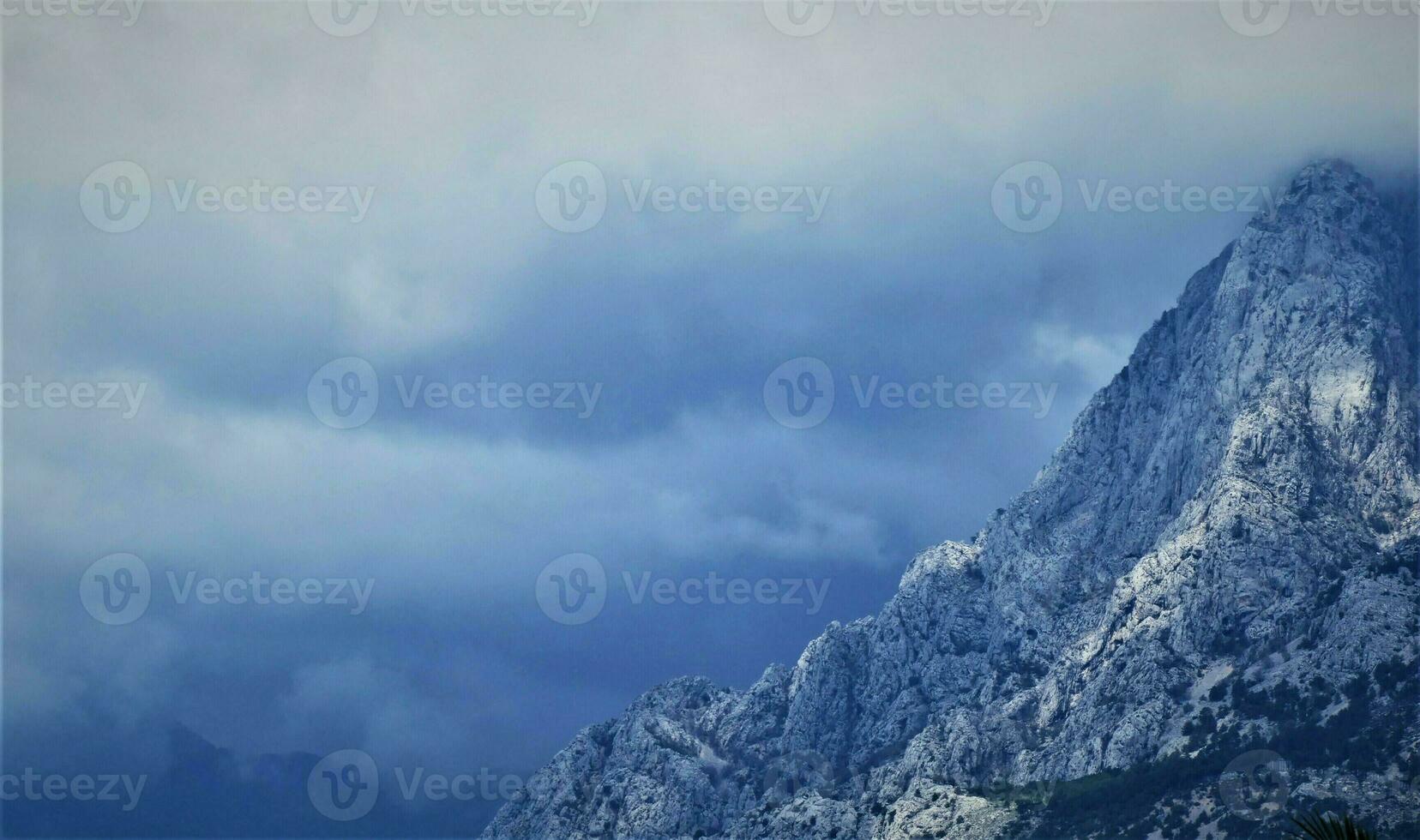 Mountain peak with clouds photo
