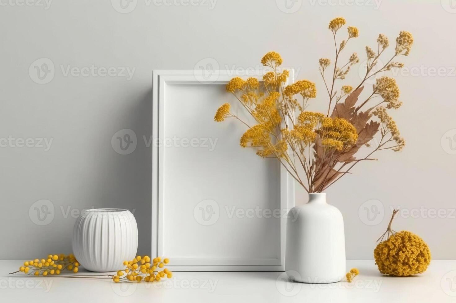 White thin vertical frame mock up beside concrete vase with dry flowers over white wall. photo
