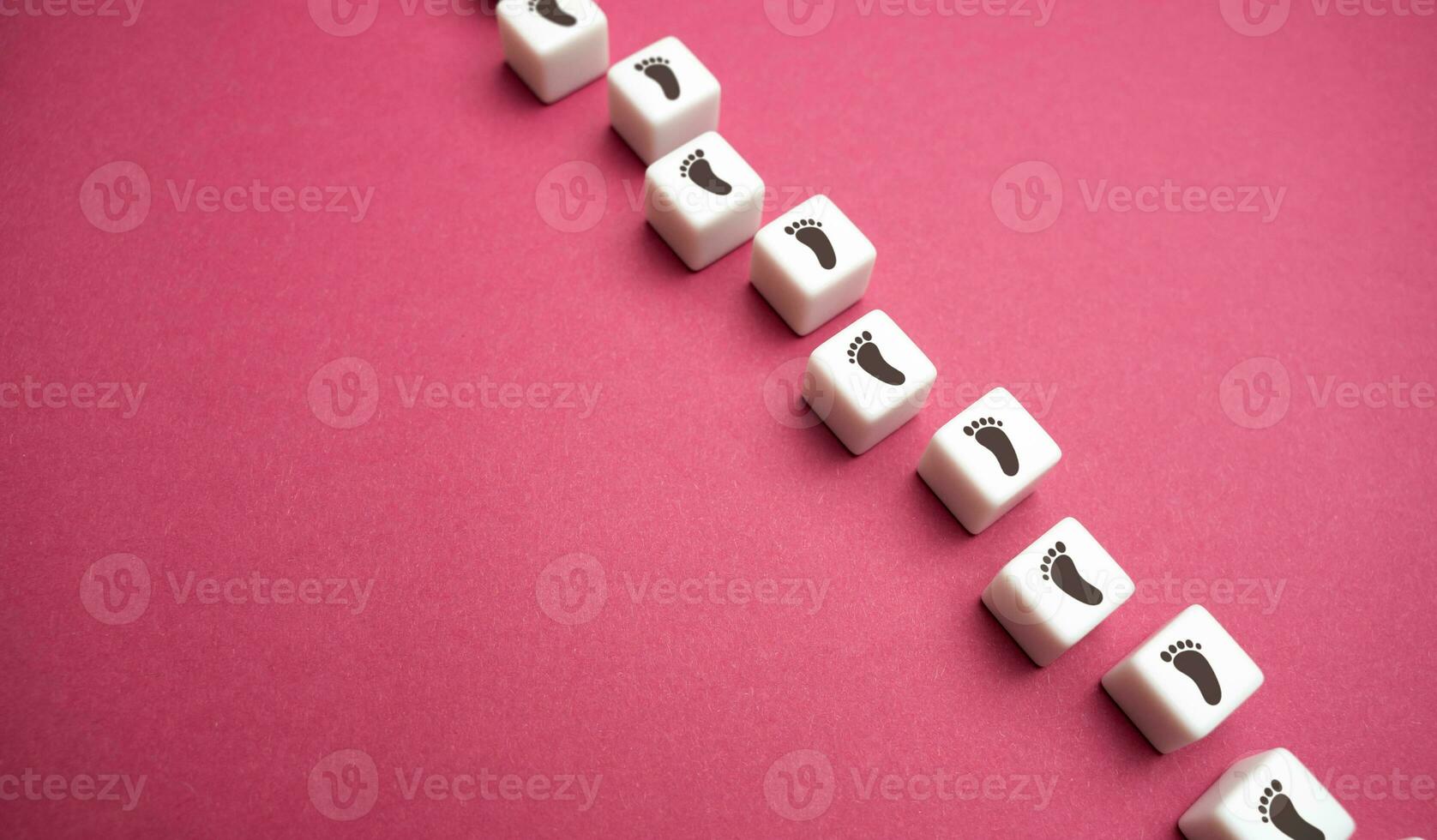Blocks with footprints on a lilac background. Pave your way. Move forward. Step by step. New opportunities. Set a target and find ways to achieve it. Motivation, self-development. photo