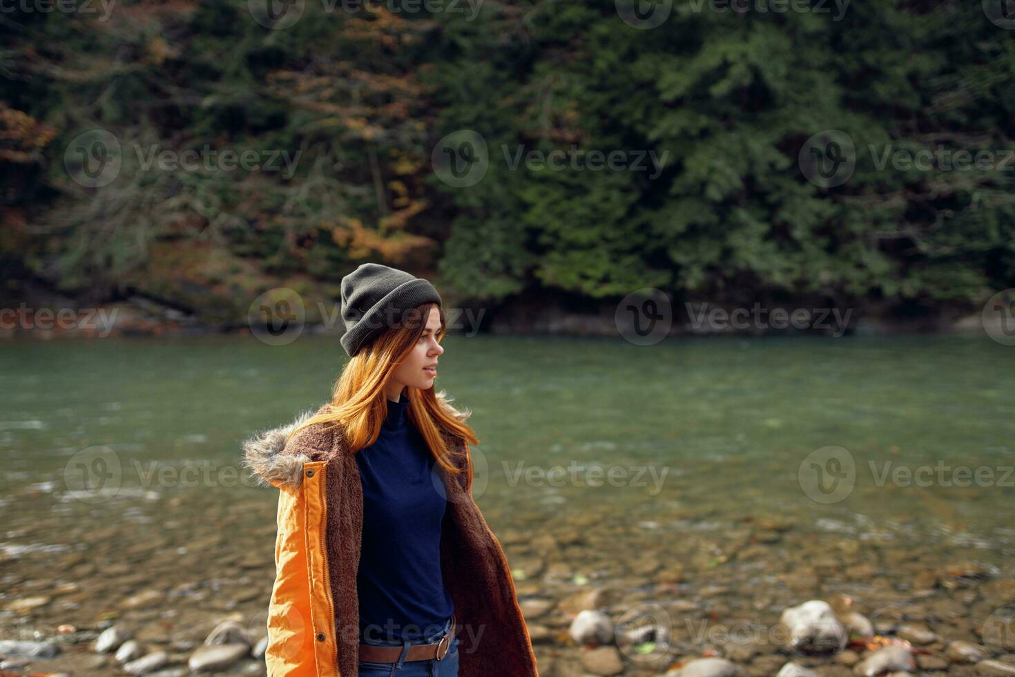 woman tourists yellow jacket nature river travel autumn photo