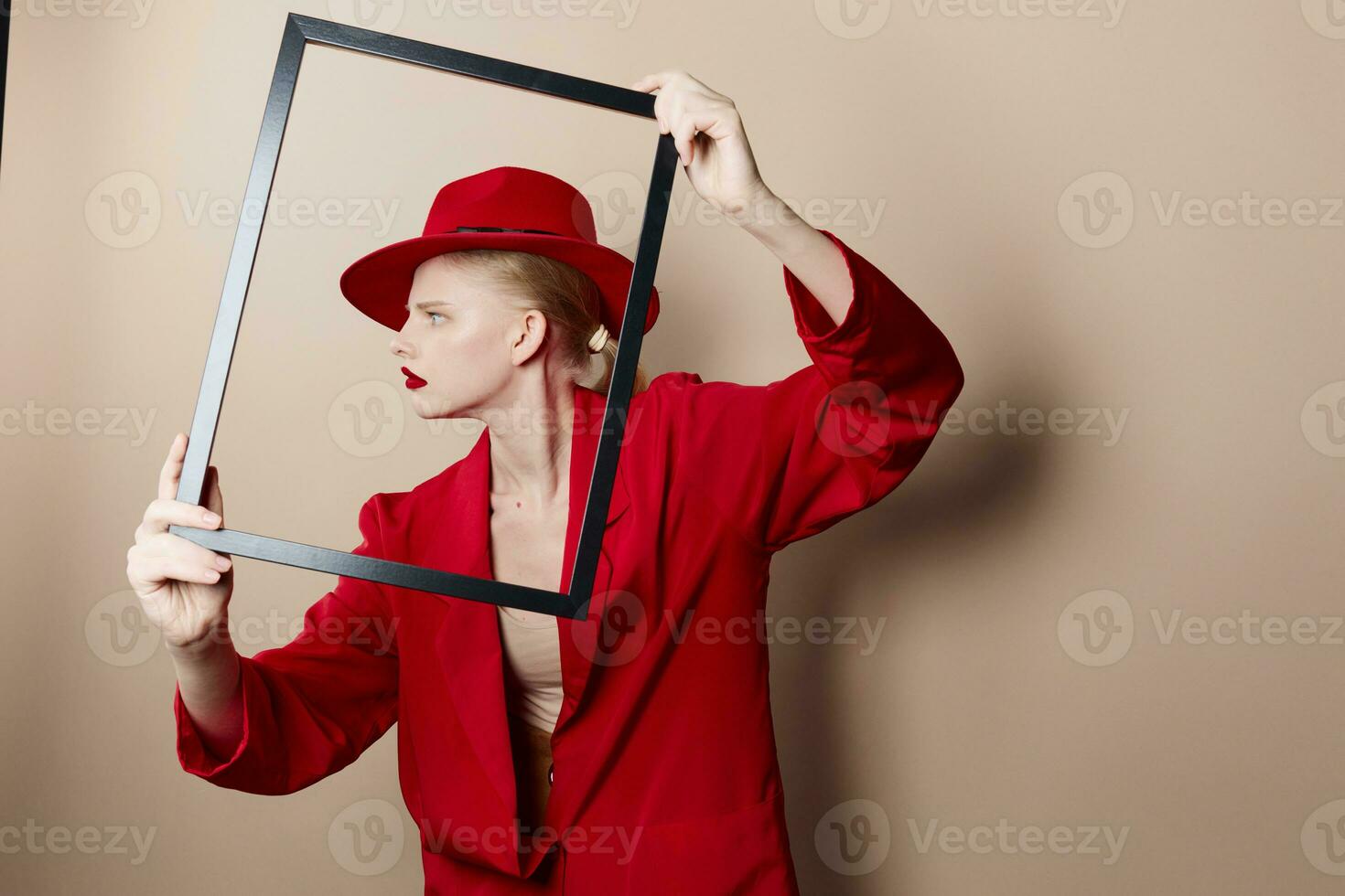 pretty woman with wooden frame posing red suit studio model unaltered photo