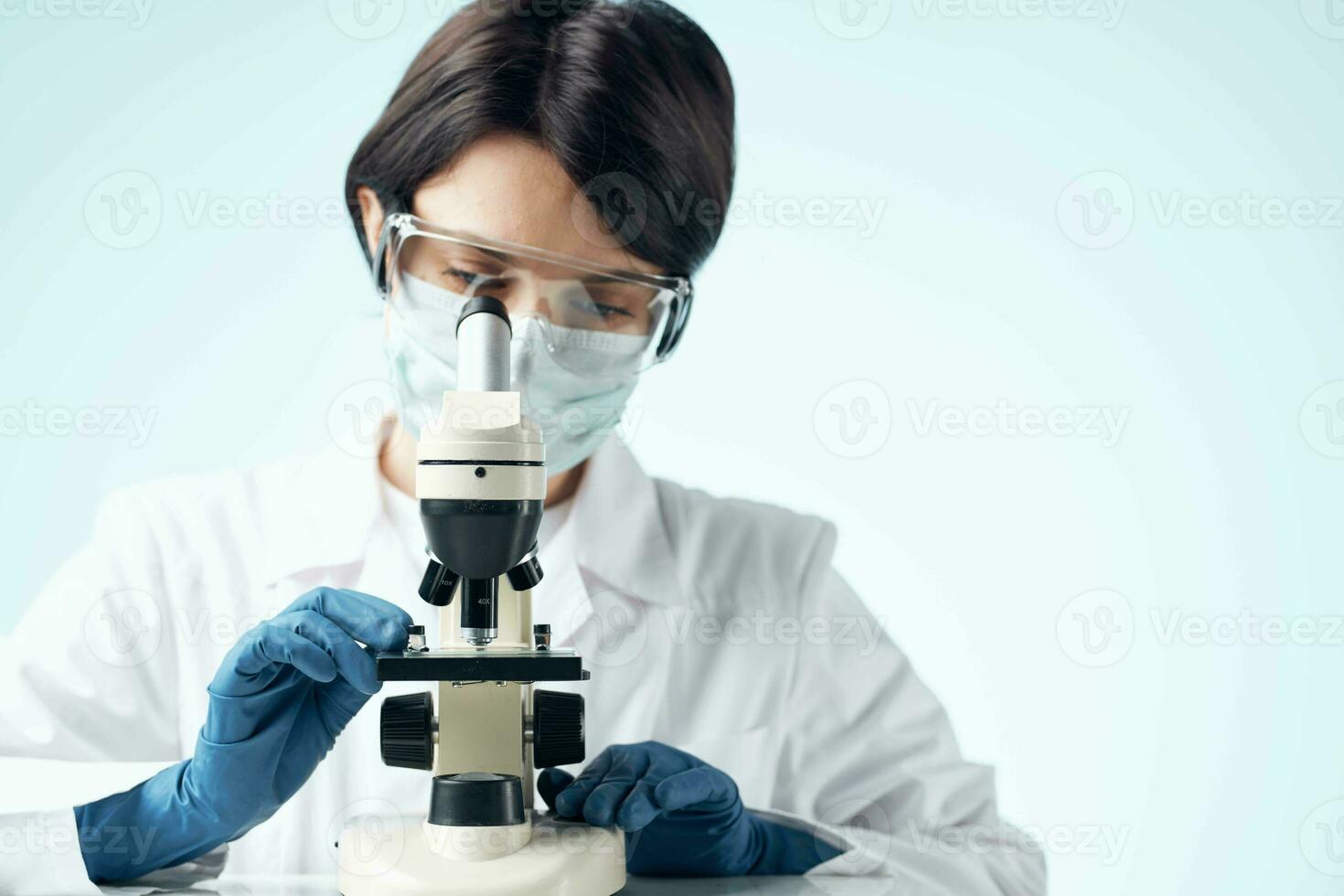 Woman in white coat microscope biotechnology science research photo